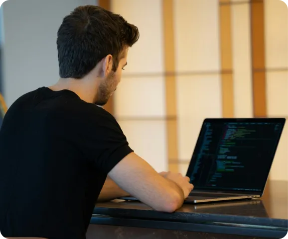 a developer writing code on a laptop