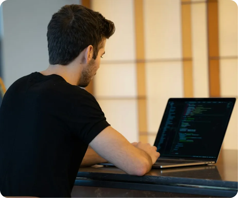 a developer writing code on a laptop