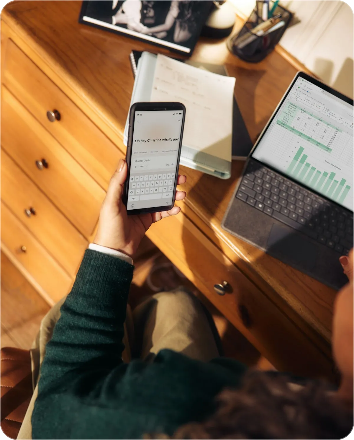 phone in hand at the desk